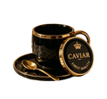 A luxury black ceramic coffee cup and saucer set with gold trim, featuring a matching gold spoon and a round branded coaster lid. The coaster lid displays a gold crown logo and the text 'CAVIAR' and 'FINEST QUALITY'.